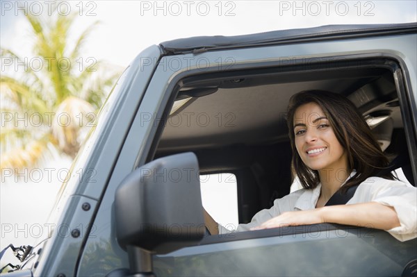 Caucasian woman smiling in car