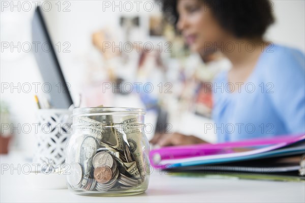 Close up of change jar on desk