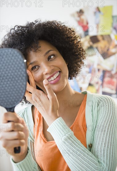 Smiling woman admiring herself in mirror