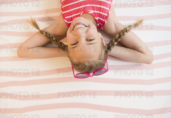 Caucasian girl smiling on beach towel