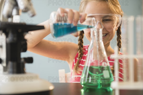Caucasian girl doing science experiment in lab