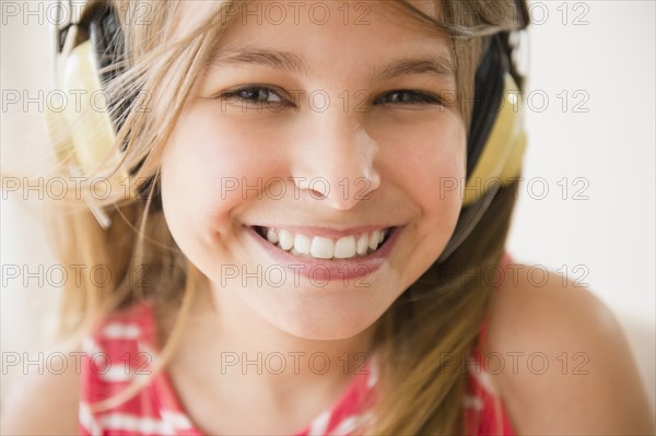 Close up of Caucasian girl wearing headphones