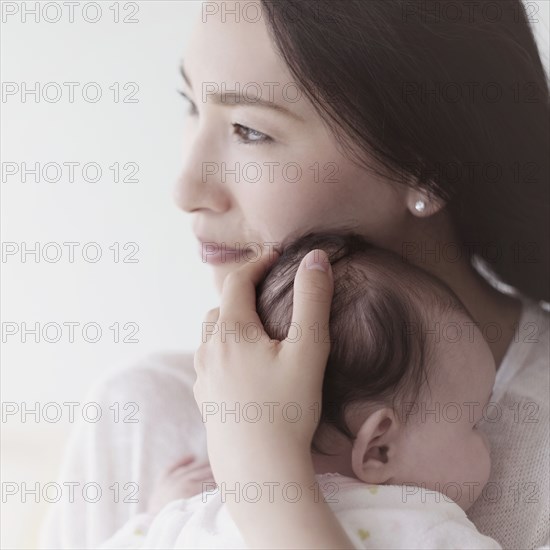 Asian mother holding baby