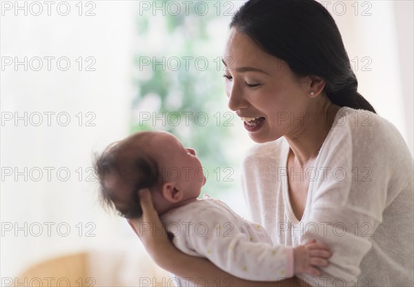 Asian mother holding baby