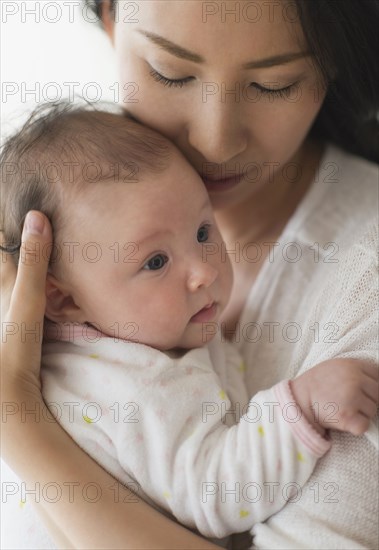 Asian mother holding baby