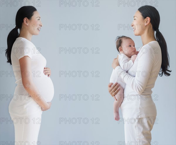 Double exposure of pregnant Asian mother before and after birth of baby