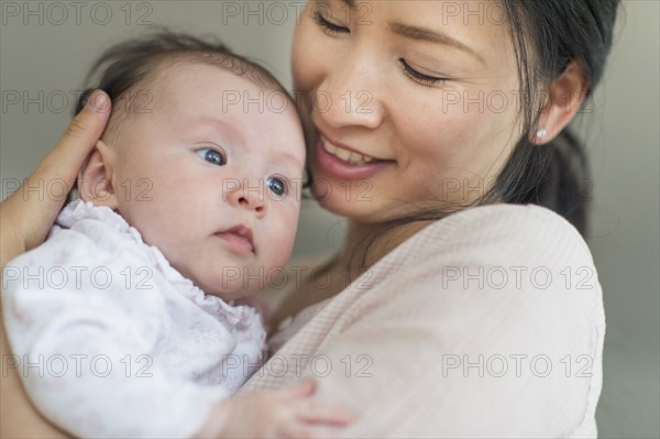 Asian mother holding baby