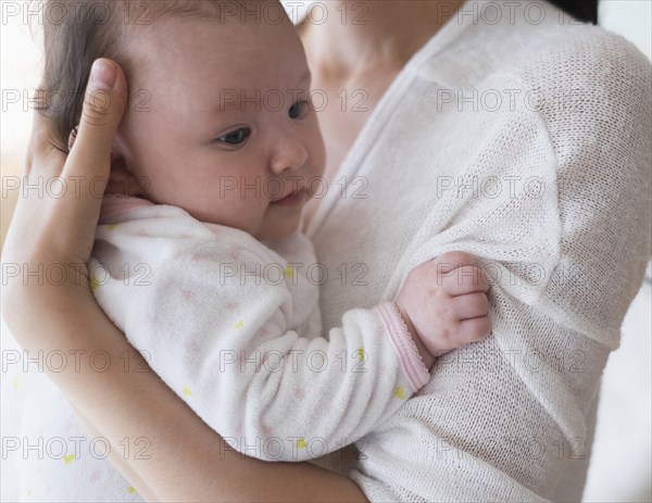 Asian mother holding baby