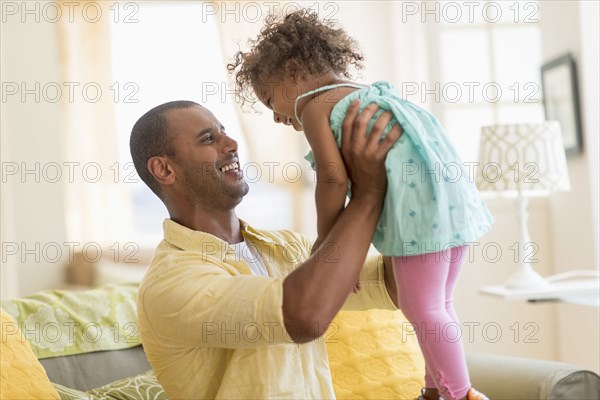 Father and daughter playing together in living room