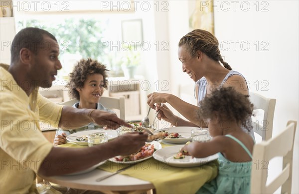 Family eating together at dining room table