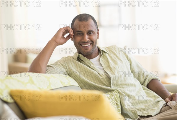 Mixed race man smiling in living room