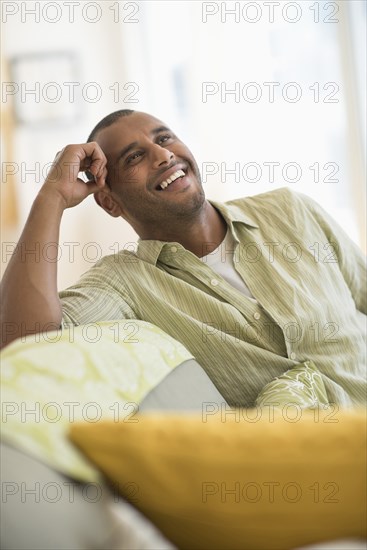 Mixed race man smiling in living room