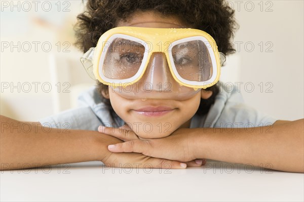 Mixed race boy wearing wet snorkel mask