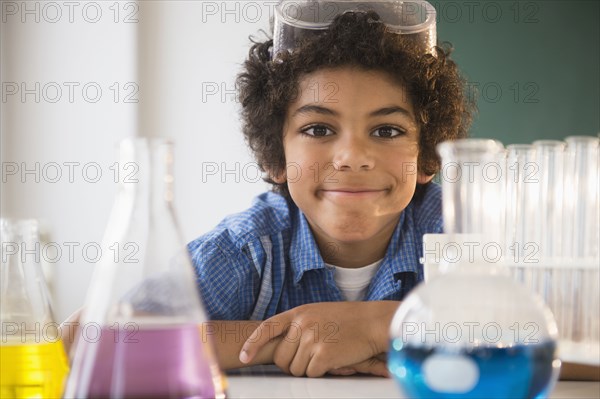 Mixed race boy sitting in classroom science lab