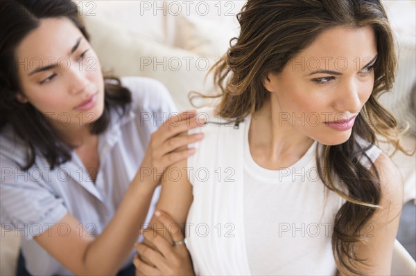 Hispanic woman comforting angry friend