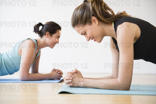 Hispanic women practicing yoga in studio
