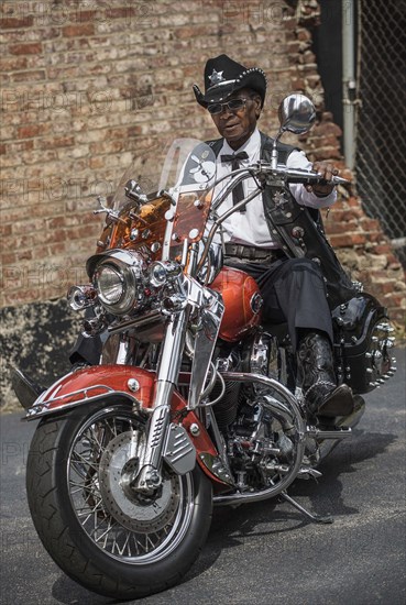 Senior African American man riding motorcycle