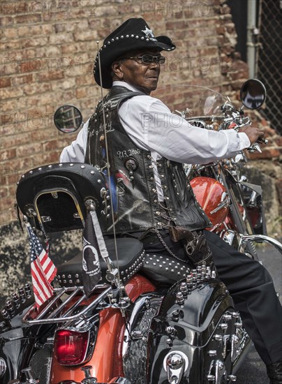 Senior African American man riding motorcycle