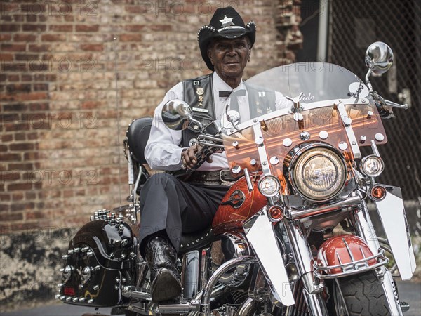 Senior African American man riding motorcycle