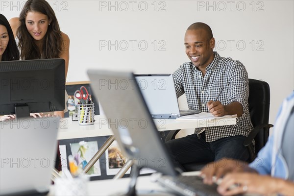 Business people working together on computers in office