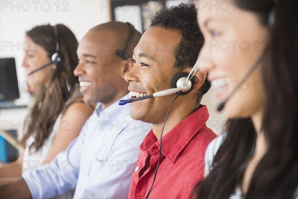 Business people wearing headsets in office