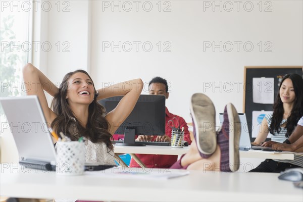 Businesswoman relaxing at desk in office