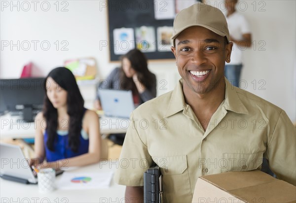 Delivery man smiling in office