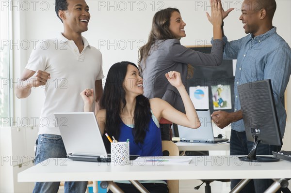 Business people cheering in office