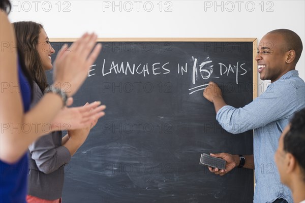 Business people cheering and preparing for launch in office