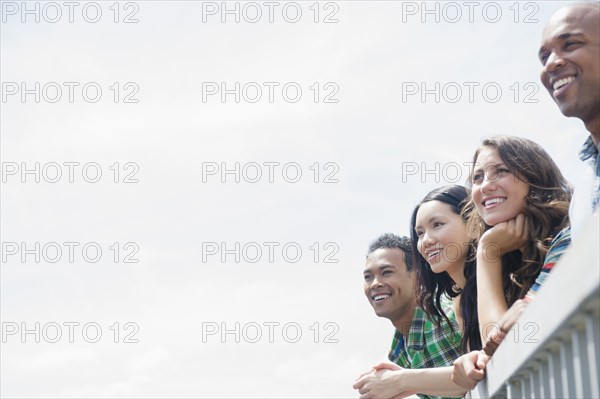 Friends admiring view from banister