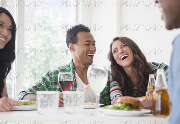 Friends laughing together at restaurant