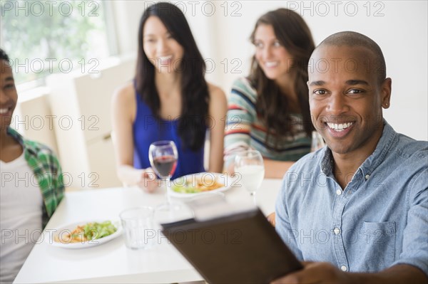 Man handing check to server at restaurant