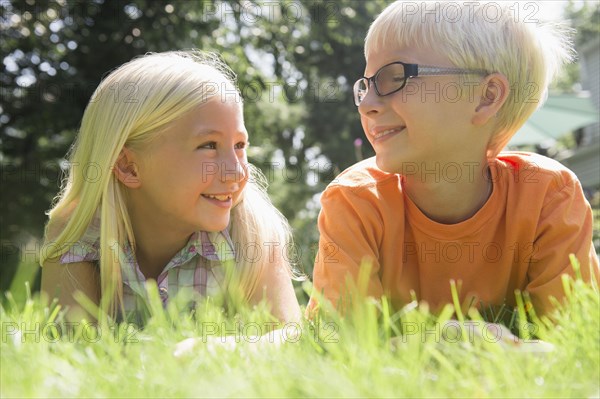 Caucasian children smiling in backyard