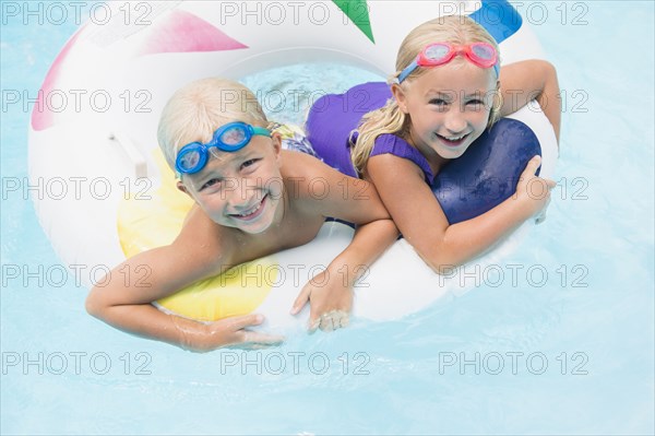 Caucasian children playing in swimming pool