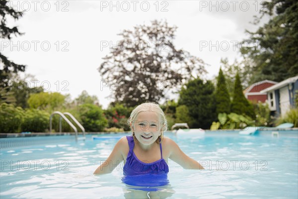 Caucasian girl in swimming pool