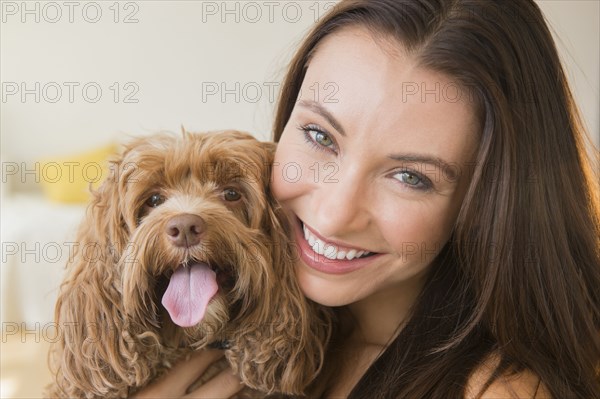 Caucasian woman holding pet dog