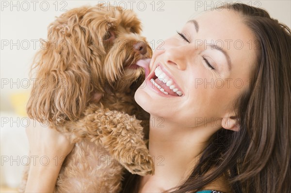 Caucasian woman playing with pet dog