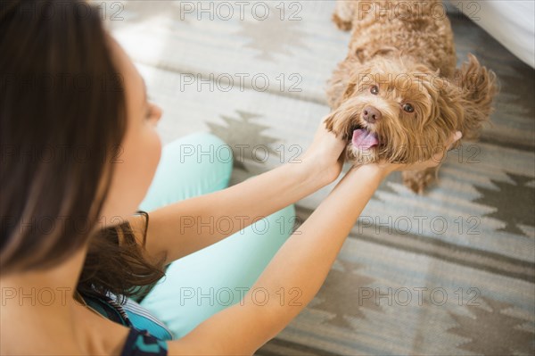 Caucasian woman petting dog