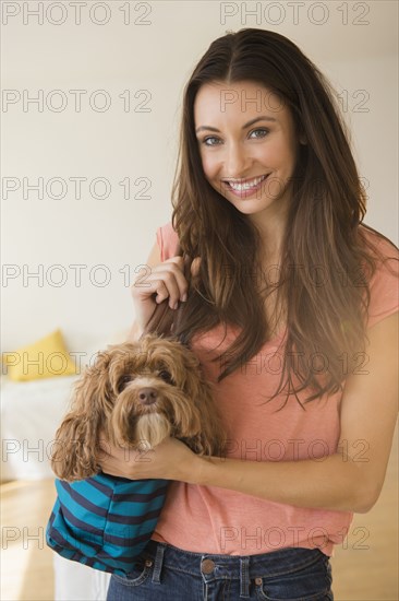 Caucasian woman holding pet dog