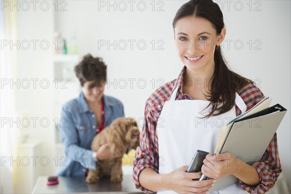 Caucasian groomer smiling in salon