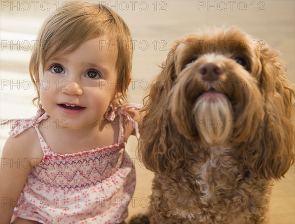 Caucasian girl hugging pet dog