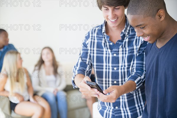 Teenage boys using cell phone