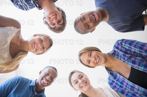 Low angle view of teenagers standing in circle