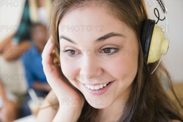 Teenage girl listening to headphones