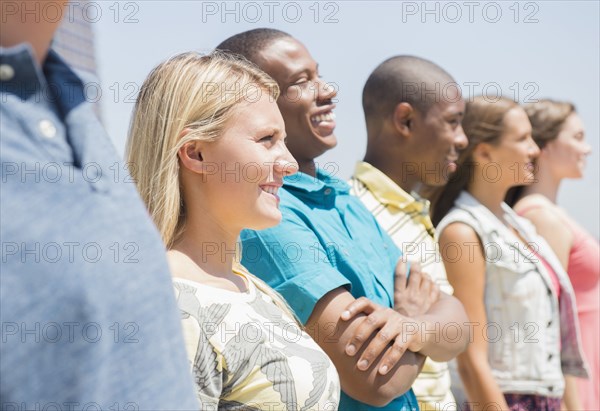Close up of teenagers standing in a row outdoors