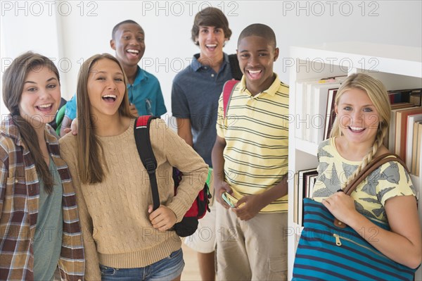 Teenage students smiling at school