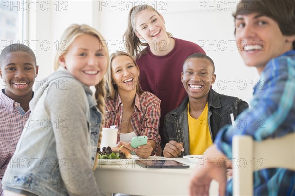 Teenagers smiling at table