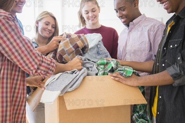 Teenagers donating clothes to charity