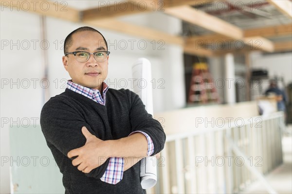 Korean businessman standing with arms crossed