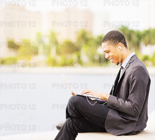 Black businessman using digital tablet outdoors